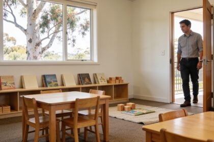 An empty Prep classroom with small tables, chairs, wooden blocks and a reading mat ready for a visit.